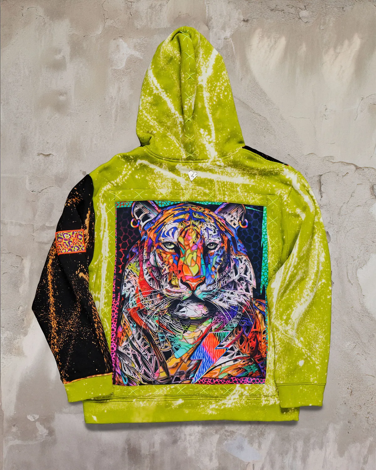 Chartreuse hoodie photographed in the studio, back panel carrying a full tiger portrait